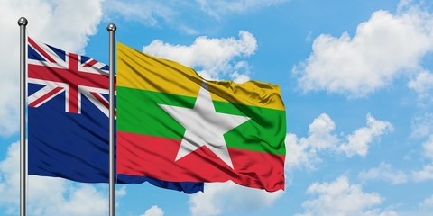 New Zealand and Myanmar flag waving in the wind against white cloudy blue sky together. Diplomacy concept, international relations.