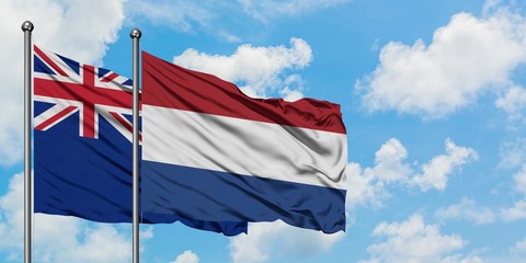 New Zealand and Netherlands flag waving in the wind against white cloudy blue sky together. Diplomacy concept, international relations.