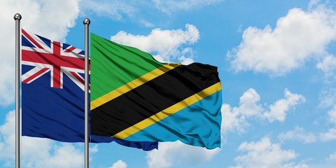 New Zealand and Tanzania flag waving in the wind against white cloudy blue sky together. Diplomacy concept, international relations.