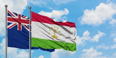 New Zealand and Tajikistan flag waving in the wind against white cloudy blue sky together. Diplomacy concept, international relations.