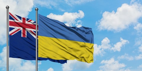 New Zealand and Ukraine flag waving in the wind against white cloudy blue sky together. Diplomacy concept, international relations.