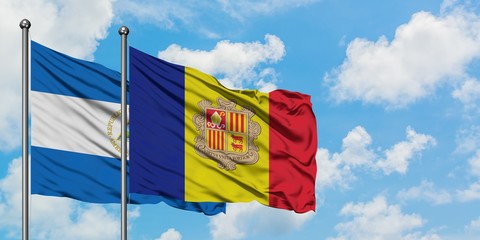 Nicaragua and Andorra flag waving in the wind against white cloudy blue sky together. Diplomacy concept, international relations.