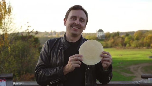 Happy man enjoys tradicional czech sweet waffer food Oplatky in the Pragu Zoo