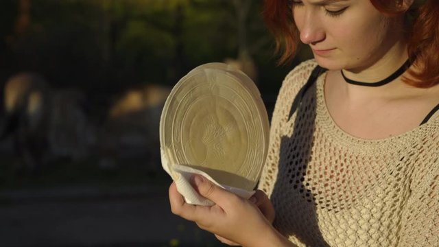 Happy redhead woman enjoys tradicional czech sweet waffer food Oplatky in the Pragu Zoo