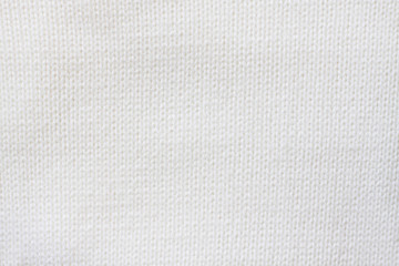 Fototapeta na wymiar Knit stitch pattern. White woolen knitwear texture. Soft knitted fabric
