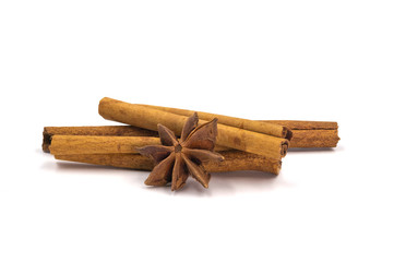 Close-up of Cinnamon sticks heap and star anise spice isolated on  white background.