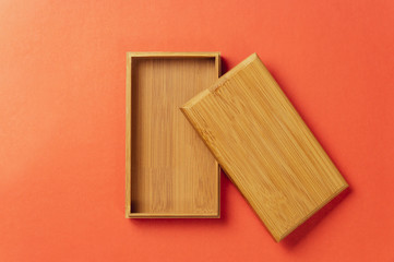 empty wooden gift box on red background, top view