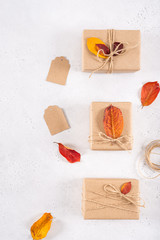 Thanksgiving day, DIY, autumn holidays preparation and creative background. Festive presents, dried leaves and handmade gift boxes, top view