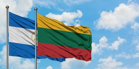 Nicaragua and Lithuania flag waving in the wind against white cloudy blue sky together. Diplomacy concept, international relations.