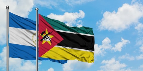 Nicaragua and Mozambique flag waving in the wind against white cloudy blue sky together. Diplomacy concept, international relations.