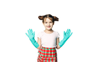 Little girl in green rubber gloves ready for cleaning. Mom's assistant isolated on a white background.
