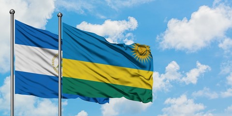 Nicaragua and Rwanda flag waving in the wind against white cloudy blue sky together. Diplomacy concept, international relations.
