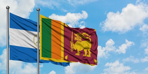 Nicaragua and Sri Lanka flag waving in the wind against white cloudy blue sky together. Diplomacy concept, international relations.