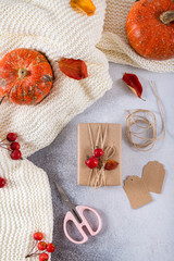 Presents for Thanksgiving day wrapped in craft paper in rustic style with natural materials. Autumn gifts with fallen leaves. Cozy autumn, eco style. Top view