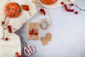 Fototapeta na wymiar Autumn gifts with fallen leaves. Presents for Thanksgiving day, birthday wrapped in craft paper in rustic style with natural materials. Cozy autumn, copy space