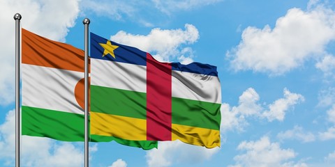 Niger and Central African Republic flag waving in the wind against white cloudy blue sky together. Diplomacy concept, international relations.