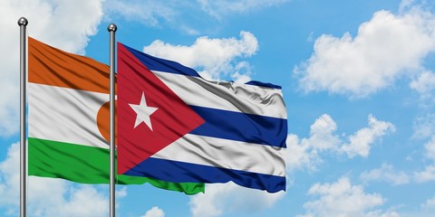 Niger and Cuba flag waving in the wind against white cloudy blue sky together. Diplomacy concept, international relations.