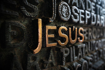 Close-up of a door of the Catholic basilica of the Sagrada Familia with the Golden inscription...
