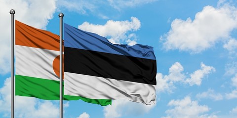 Niger and Estonia flag waving in the wind against white cloudy blue sky together. Diplomacy concept, international relations.