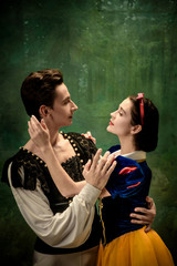 Young ballet dancers as a Snow White's characters in forest. Flexible caucasian artists dance like...