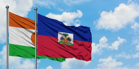 Niger and Haiti flag waving in the wind against white cloudy blue sky together. Diplomacy concept,...