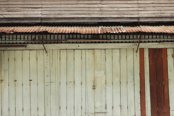 vintage wooden door on facade of old building in Thailand