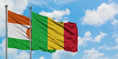 Niger and Mali flag waving in the wind against white cloudy blue sky together. Diplomacy concept, international relations.