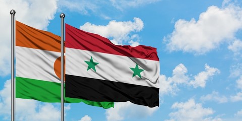 Niger and Syria flag waving in the wind against white cloudy blue sky together. Diplomacy concept,...