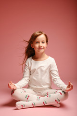 girl sitting on the floor on a pink background