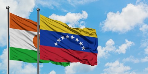 Niger and Venezuela flag waving in the wind against white cloudy blue sky together. Diplomacy concept, international relations.