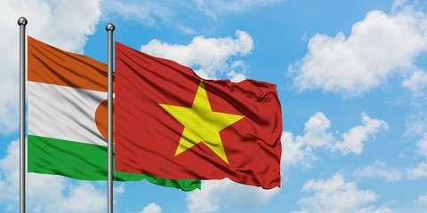 Niger and Vietnam flag waving in the wind against white cloudy blue sky together. Diplomacy concept, international relations.