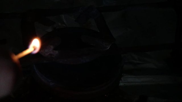 Gas burner stove for cooking, yellow and blue flames, burning gas, paper. The use of oxygen gas is burning, a large flame. The fire in the kitchen burning room. Set fire Night dark flash fire.