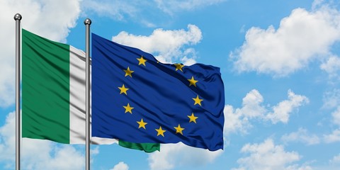 Nigeria and European Union flag waving in the wind against white cloudy blue sky together. Diplomacy concept, international relations.