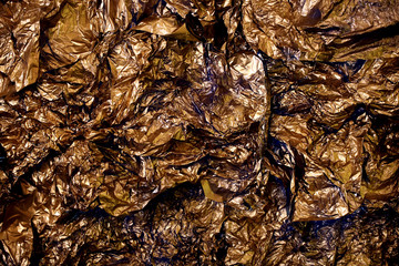 Golden shiny wrappers in crushed formation