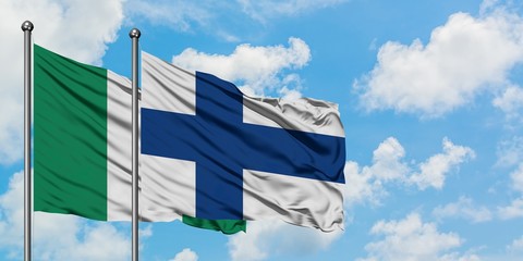 Nigeria and Finland flag waving in the wind against white cloudy blue sky together. Diplomacy...