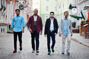 Fototapeta premium Group of four indian teen male students. Classmates spend time together.