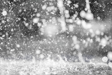 blue color tone of close up rain water drop falling to the floor in rainy season 