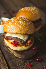 Big burger with cheese and cranberry sauce