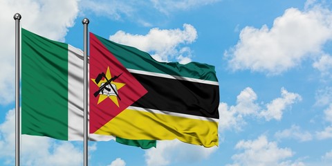 Nigeria and Mozambique flag waving in the wind against white cloudy blue sky together. Diplomacy concept, international relations.