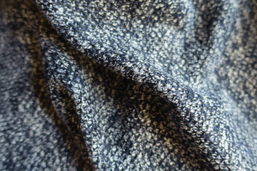 Closeup of draped blue grey melange woolen fabric