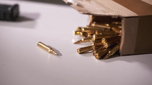 Close up static shot of box with bullet ammunition on a table
