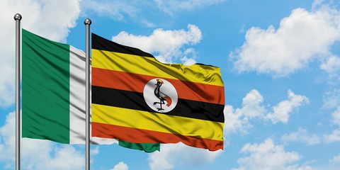 Nigeria and Uganda flag waving in the wind against white cloudy blue sky together. Diplomacy concept, international relations.