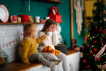Cozy funny siblings together in kitchen,Christmas