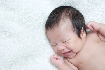 Fototapeta na wymiar baby boy asian. Newborn child tired and hungry in hand mother. Children cry. Infant screaming. sadness