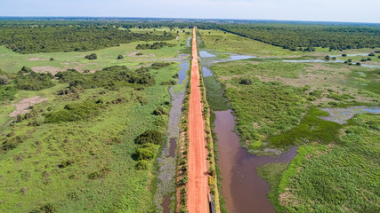 Aerial view of Transpantaneira dirt road crossing straight the typical landscape of North Pantanal...