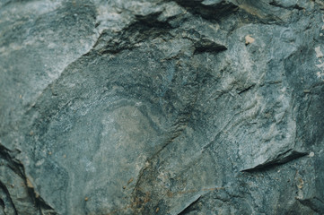 Naklejka premium Natural stone texture with a natural pattern, cracks and irregularities. Soft focus, shallow depth of field