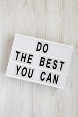 'Do the best you can' words on a modern board on a white wooden background, top view. Overhead, from above, flat lay. Close-up.