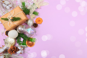 Christmas border. Christmas gifts, fir branches on color background. Flat lay, top view, copy space - Image