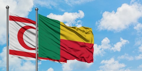Northern Cyprus and Benin flag waving in the wind against white cloudy blue sky together. Diplomacy concept, international relations.