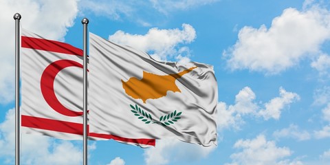 Northern Cyprus and Cyprus flag waving in the wind against white cloudy blue sky together. Diplomacy concept, international relations.